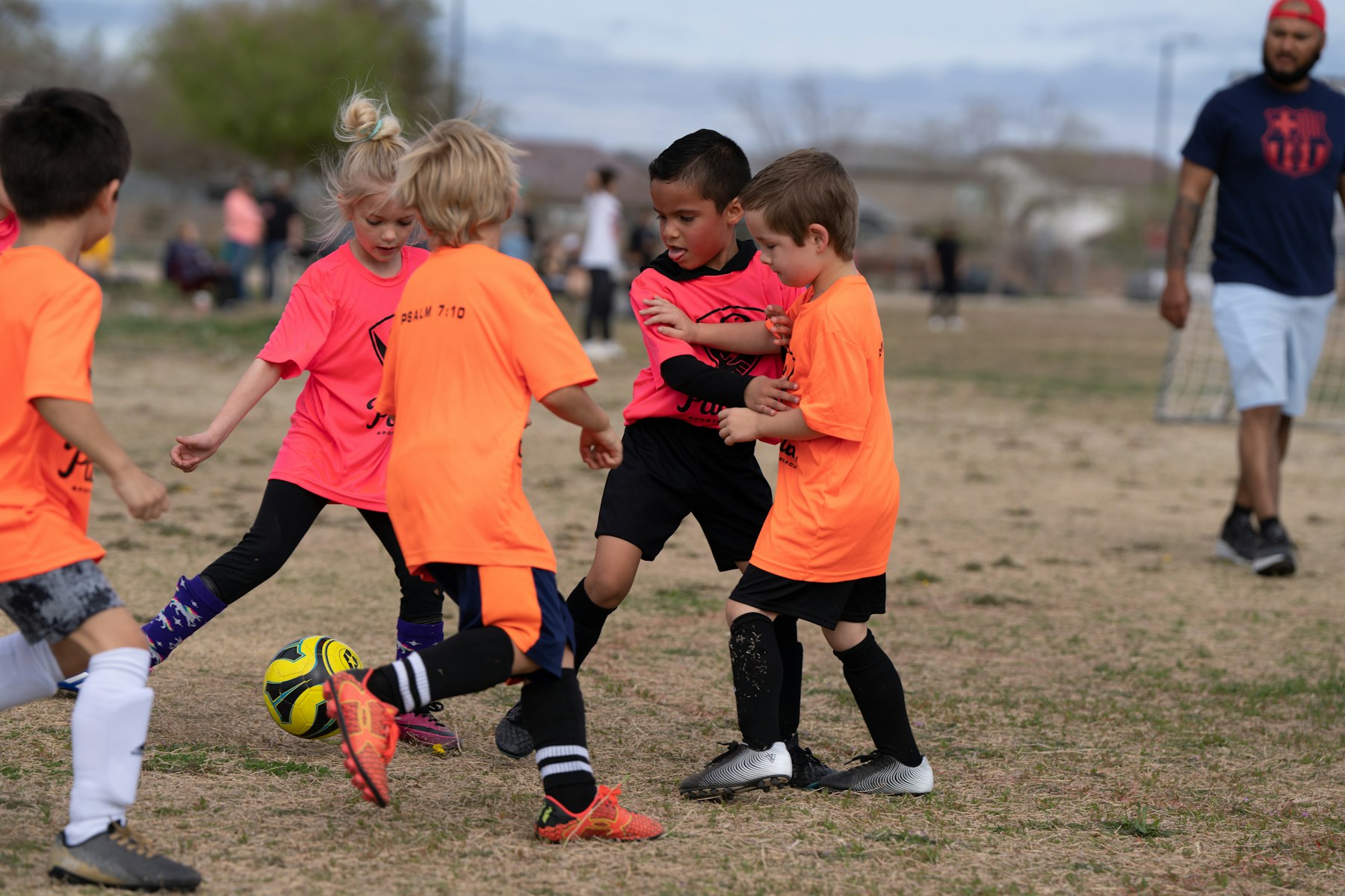 Young players clustered around the ball during a rec session